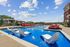 Luxurious outdoor pool area with stylish lounge chairs and shaded cabanas, perfect for relaxation and enjoying sunny days.