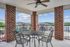 Charming balcony with stylish metal furniture, offering scenic views and a cozy outdoor retreat.