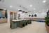Modern communal dining area with chic velvet chairs, stylish pendant lighting, and vibrant artwork enhancing the elegant interior.