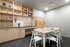 Inviting modern study area with stylish shelving, elegant decor, and cozy dining table set for creativity and productivity.