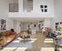 Bright and modern open-concept living room with high ceilings, elegant decor, and a stylish kitchen island.