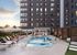 Modern apartment complex with vibrant outdoor pool and lounging area, featuring elegant seating and lively social gathering spaces.