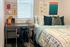 Cozy bedroom with a stylish desk, modern decor, and inviting bedding, perfect for comfort and productivity.
