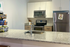 Modern kitchen with sleek granite countertops, stainless steel appliances, and elegant cabinetry offering a fresh and inviting cooking space.
