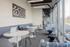 Bright and modern communal area with sleek tables, comfortable seating, and expansive windows for natural light.