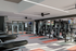 Modern fitness center featuring state-of-the-art gym equipment, sleek design, and vibrant flooring, perfect for your workout needs.
