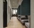 Contemporary hallway with cozy booth seating, elegant decor, and bright natural lighting, perfect for a modern workspace.