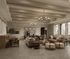 Elegant open-concept living room with high ceilings, cozy seating arrangements, and abundant natural light from large windows.