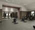 Modern fitness center with state-of-the-art exercise bikes, sleek mirrored walls, and natural light streaming through large windows.