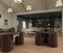Elegant lounge area with stylish seating, contemporary lighting, and a sophisticated bookshelf creating a cozy ambiance.