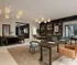 Elegant open-concept living area featuring modern furnishings, stylish pendant lighting, and a chic bookshelf, perfect for luxurious living and entertaining.