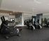 Modern fitness center with state-of-the-art treadmills, exercise bikes, and stylish mirrors for an invigorating workout experience.