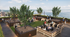 Rooftop lounge area overlooking the water at Theory Madison, featuring modern seating areas, firepits, string lights, and greenery with students relaxing and socializing.