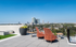 Breathtaking rooftop terrace with stylish seating, vibrant potted plants, and expansive city skyline views.