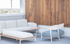 Chic modern terrace with stylish seating featuring a cozy light grey sofa, elegant wooden accents, and a serene outdoor ambiance.