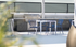 Modern outdoor grilling area with sleek barbecue, stylish blue chairs, and contemporary design.