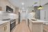 Modern kitchen design with elegant pendant lighting, sleek stainless steel appliances, and chic marble countertops.