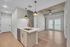 Modern living space with elegant open-concept design featuring cozy seating area, stylish dining set, and sleek kitchen island overlooking a serene landscape.