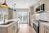 Modern kitchen design with elegant pendant lighting, sleek stainless steel appliances, and chic marble countertops.