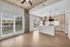 Modern living space with elegant open-concept design featuring cozy seating area, stylish dining set, and sleek kitchen island overlooking a serene landscape.
