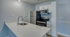 Contemporary kitchen with sleek white cabinetry, stainless steel appliances, and a stylish quartz countertop with modern sink.