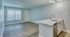 Modern apartment interior featuring elegant wood flooring, a chic open-plan layout, and a sleek kitchen with quartz countertops and stainless steel sink.