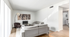 Bright and modern living room with a sleek gray sectional sofa, stylish artwork, and abundant natural light.