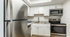 Modern kitchen with sleek stainless steel appliances, granite countertops, and crisp white cabinetry.