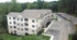 Charming apartment complex with beautifully landscaped grounds, nestled amidst lush greenery. Ideal for serene living.