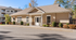 Charming apartment clubhouse with classic architectural design and neatly landscaped surroundings.