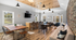 Chic communal space with modern decor, featuring a wooden dining table, cozy seating, and a stylish bar area with ambient lighting.