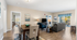 Bright and inviting open-plan living space with modern dining area, cozy seating, and a scenic balcony view.