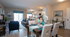 Chic open-concept living area with elegant dining space, cozy seating, and modern decor, featuring natural light and stylish accents.