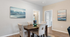 Chic dining room with elegant artwork and a modern table set, offering a cozy ambiance in a stylish apartment.