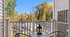 Charming balcony view overlooking lush autumn trees, complete with a cozy seating area perfect for relaxation.