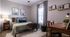 Cozy bedroom with a neatly made bed, stylish decor, and natural light streaming through a window.