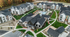 Aerial view of a picturesque residential community surrounded by lush greenery and water features.