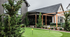 Outdoor recreational area with a lively pickleball court surrounded by lush greenery and modern residential buildings.