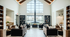 Chic living room featuring a modern central fireplace, leather sofas, and floor-to-ceiling windows offering garden views.