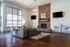 Community clubhouse with a couch facing the fireplace and 2 flat screen TVs