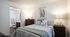 Elegant bedroom with modern decor, cozy bedding, and soft lighting, featuring an en-suite bathroom for ultimate convenience and comfort.