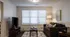 Cozy living room with ample natural light, featuring a plush brown sofa, stylish decor, and a modern entertainment center.