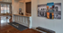 Elegant office lobby with a modern reception desk, polished floors, and stylish wall art reflecting a vibrant cityscape.