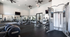 Bright and modern fitness center featuring state-of-the-art exercise equipment, large mirrors, and ample natural light.