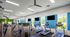Bright, modern fitness center featuring state-of-the-art treadmills, weight machines, and large windows offering a scenic view.