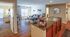 Charming apartment interior showcasing an open-plan living area with a cozy lounge, modern kitchen with granite countertops, and an inviting workspace.