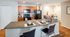 Inviting kitchen featuring sleek granite countertops, modern appliances, and a cozy breakfast bar with stylish seating.