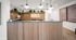 Modern reception area with elegant wooden accents, stylish lighting, and vibrant greenery for a welcoming atmosphere.