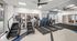 Modern fitness center with state-of-the-art treadmills and stair climbers, complemented by natural lighting and sleek interior design.