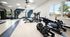 Bright and modern fitness center featuring advanced weightlifting equipment and vibrant decor with large windows providing a scenic view outside.